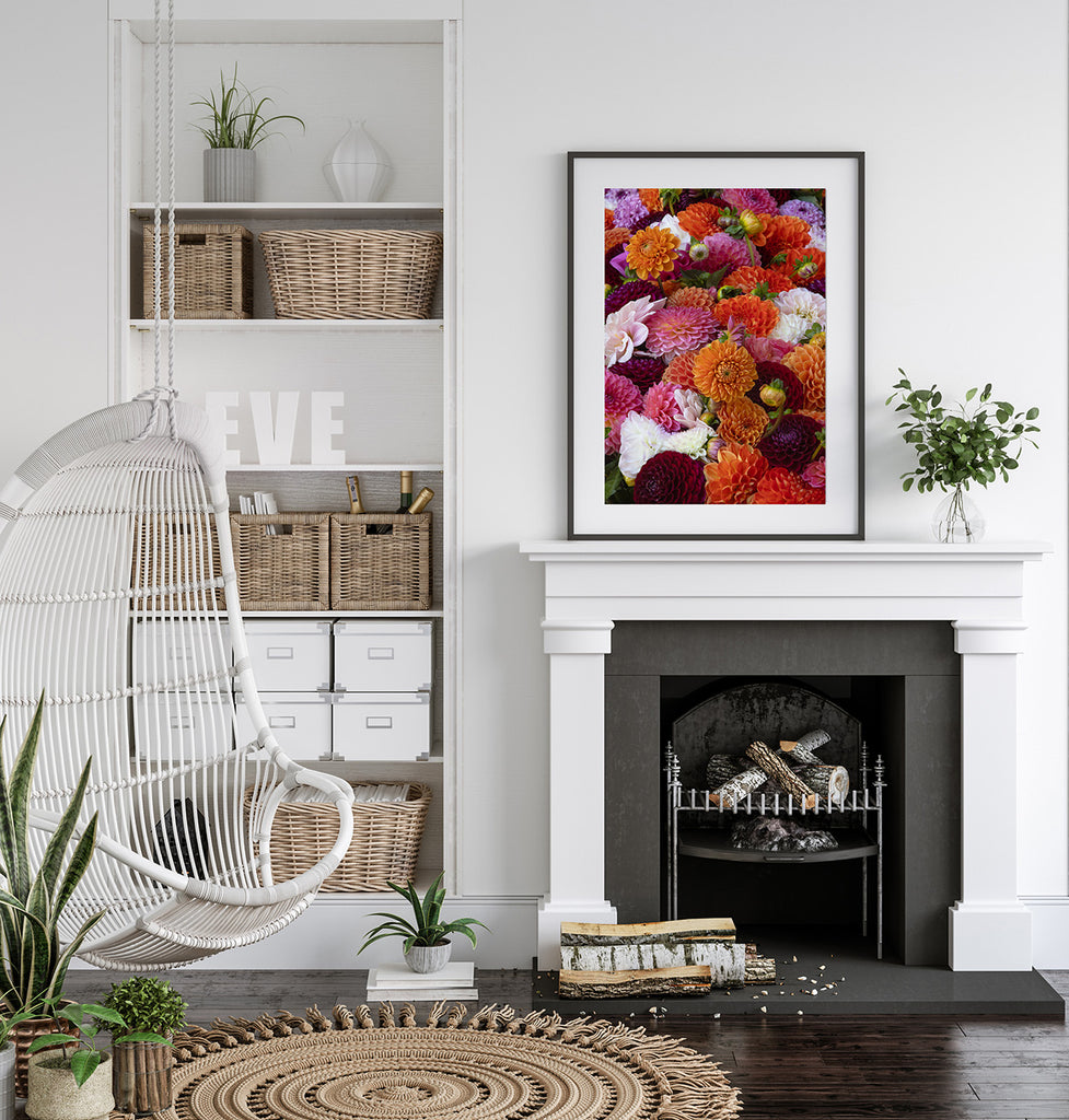 Living room with a white fireplace, hanging chair, and colorful floral artwork.