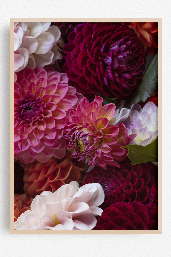 Framed artwork of colorful flowers with a wooden frame.