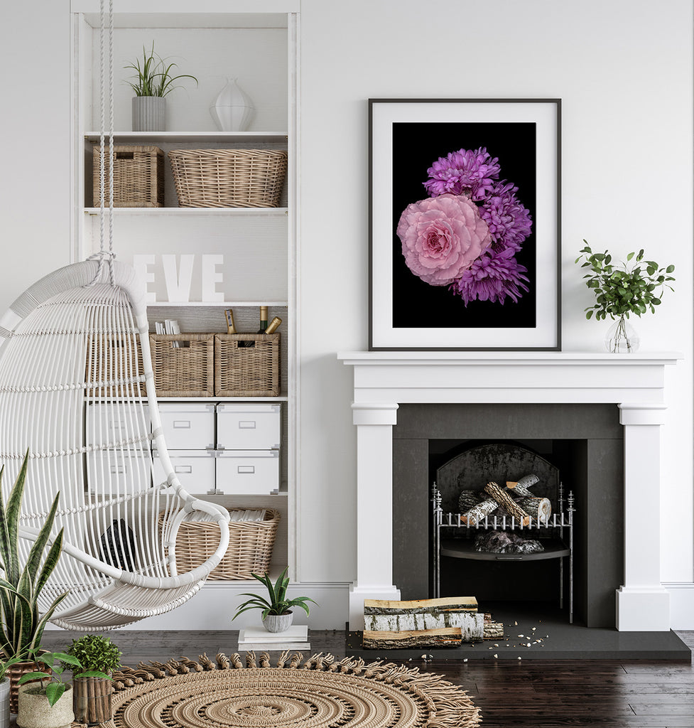 Living room with a fireplace, hanging chair, and floral artwork.