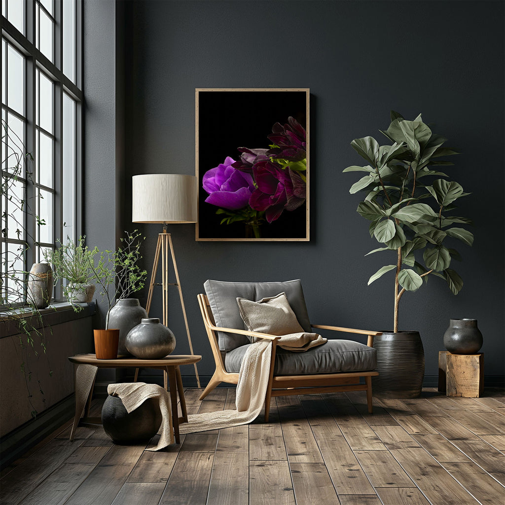 Modern living room with a gray armchair, decorative plants, and a dark wall with a floral artwork.